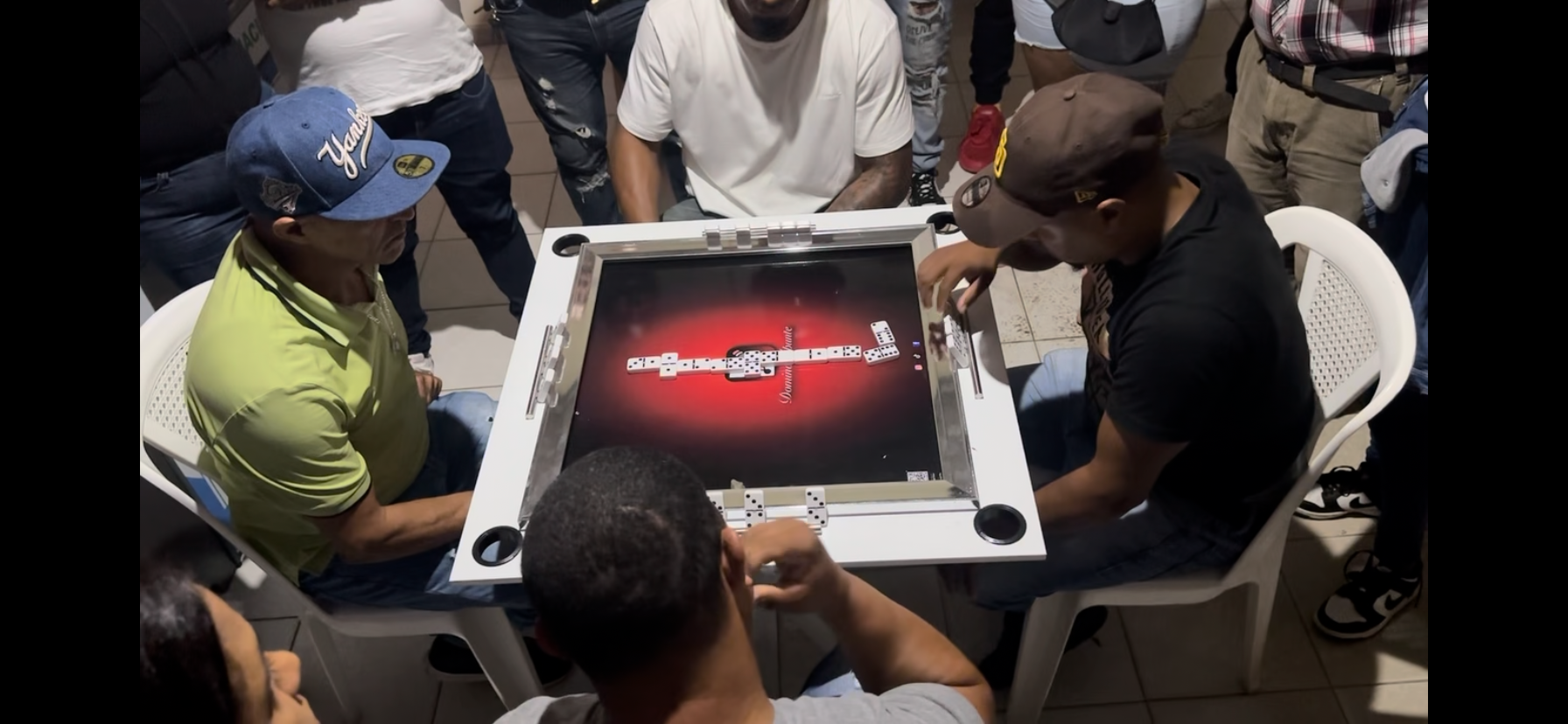 a group of friends playing domino in a Domino Apunte table